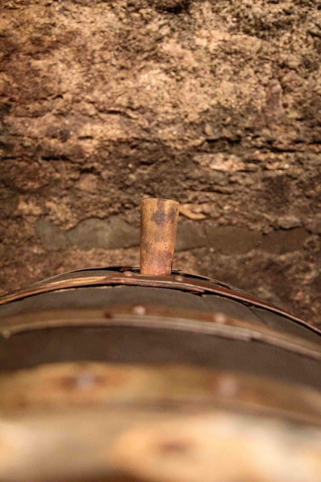 Fischborn-Schenk Müller-Thurgau bottles on a wine barrel beside hydrangeas
